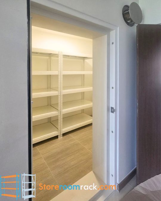 Two bays of boltless shelving installed along the wall of a BTO household shelter, seen through the open blast door